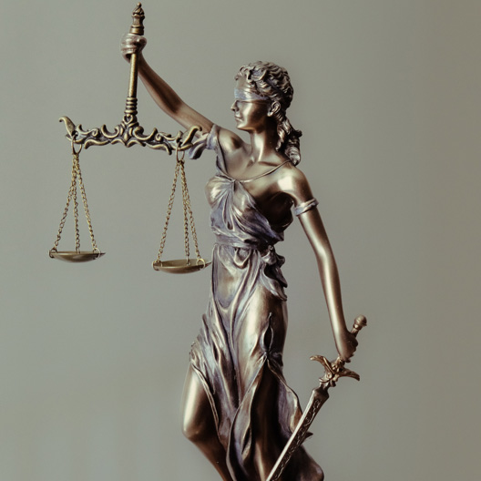 side view of Statue of Lady Justice holding scales and sword